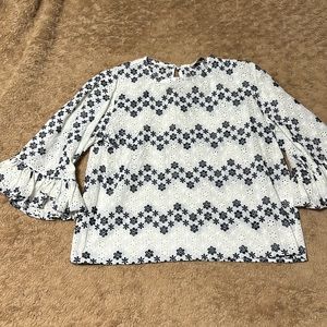 Lace eyelet shirt with bell sleeves.